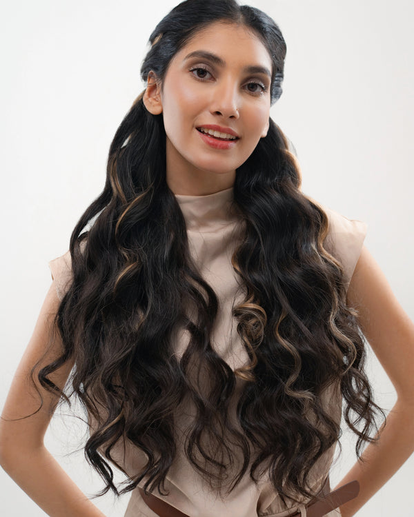 Black hair extensions featuring warm caramel honey highlights for a rich tone