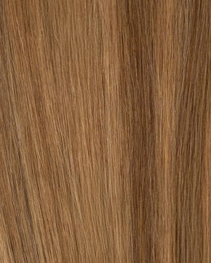 Golden brown hair extensions featuring beige blonde highlights for a soft contrast