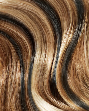 Natural black clip in hair extensions with caramel honey highlights for a soft blended look