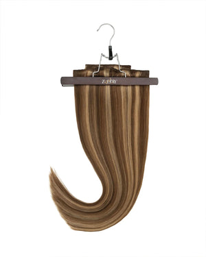 Clip in hair extensions in brown with blonde highlights for added dimension